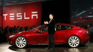 Tesla Car with elon musk standing in front of crowd