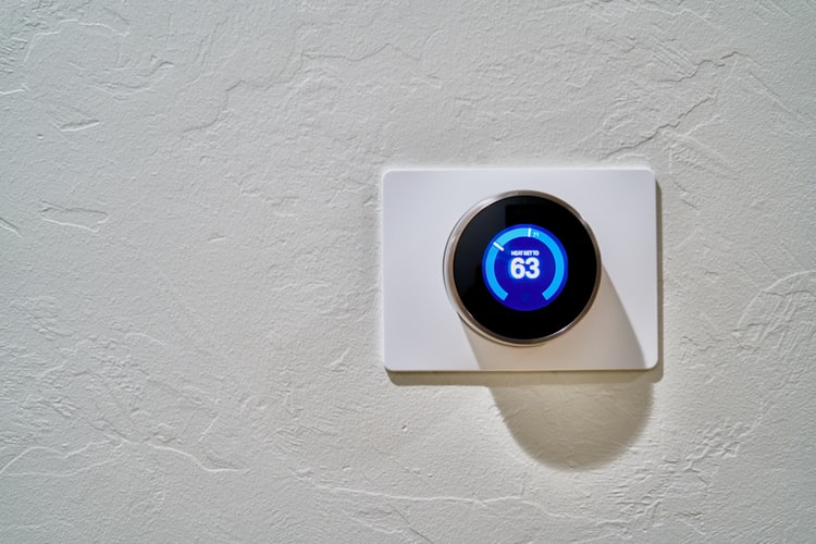 Programmable digital thermostat, on a clean white wall