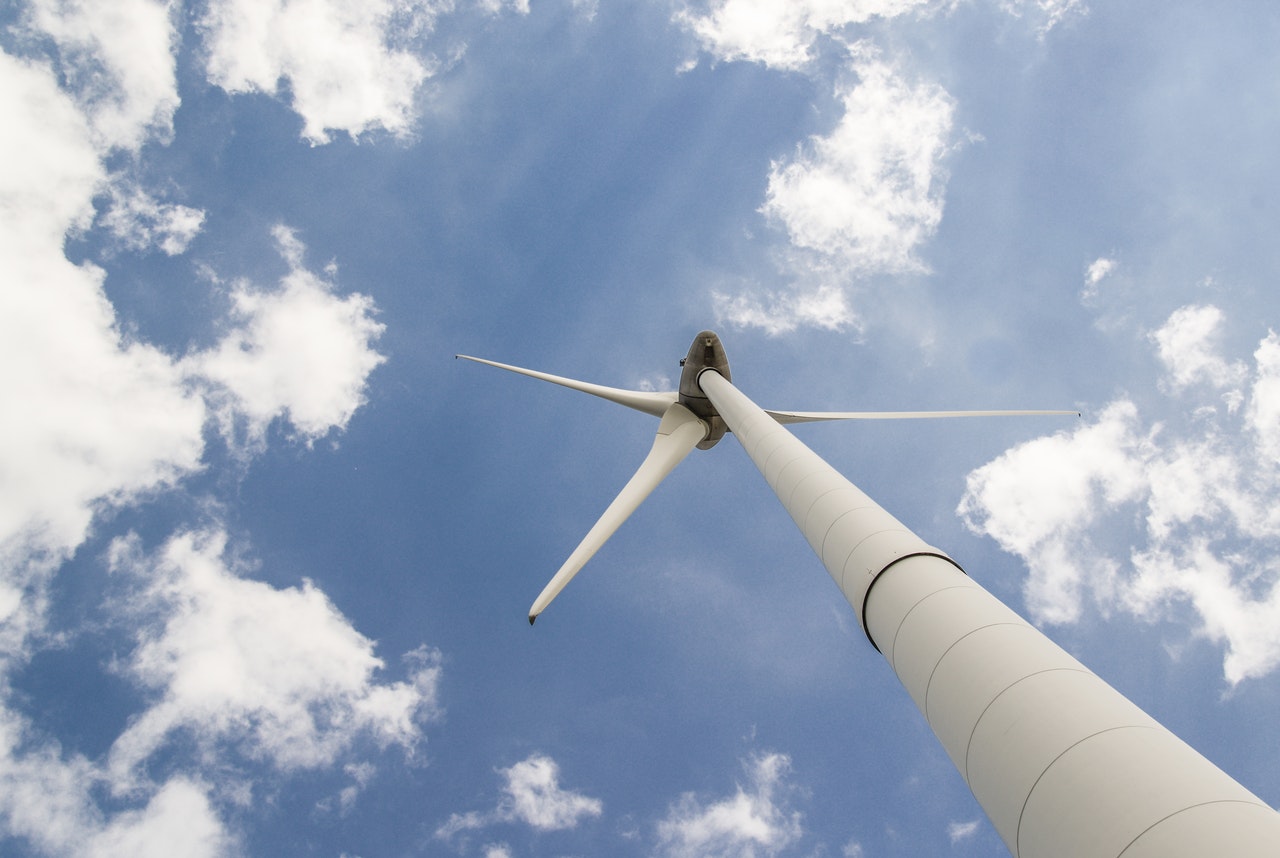 White windmill under cloudy sky